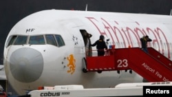 Cảnh sát giúp hành khách ra khỏi chuyến bay ET 702 của hãng hàng không Ethiopian Airlines bị không tặc tại Sân bay Cointrin ở Geneva, ngày 17/2/2014.
