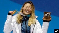 FILE - women's halfpipe gold medalist Chloe Kim, of the United States, poses during the medals ceremony at the 2018 Winter Olympics, in Pyeongchang, South Korea, Feb. 13, 2018.
