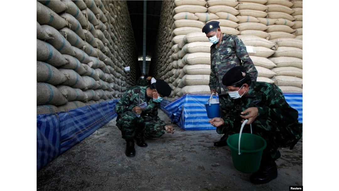Soldiers check rice stocks at a warehouse in Ayutthaya province, north of Bangkok, Thailand, July 3, 2014.