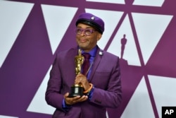 FILE - Spike Lee poses with the award for best adapted screenplay for "BlacKkKlansman" in the press room at the Oscars on Sunday, Feb. 24, 2019, at the Dolby Theatre in Los Angeles. (Photo by Jordan Strauss/Invision/AP)
