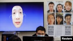 A software engineer works on a facial recognition program that identifies people when they wear a face mask at the development lab of the Chinese electronics manufacturer Hanwang (Hanvon) Technology in Beijing.