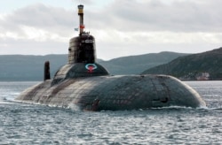 One of Russia's largest Soviet-built nuclear submarines, Typhoon (Akula) class, heaves ahead in the Barents Sea on Russia's Arctic Coast.