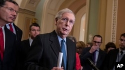 Senate Majority Leader Mitch McConnell, R-Ky., joined at left by Sen. John Barrasso, R-Wyo., and Sen. Todd Young, R-Ind., speaks to reporters asking about the threat of another government shutdown following a strategy meeting in Washington, Jan. 29, 2019