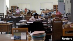 FILE - Employees work at the Central Bank's headquarters in Naypyitaw, Myanmar.