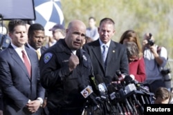 San Bernardino Police Department Chief Jarrod Burguan, center, speaks during a news conference in San Bernardino, Calif., Dec. 3, 2015.