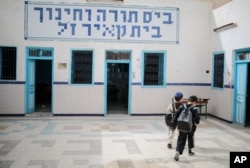 Boys walk inside a Talmudic school at Hara Kbira, on the island of Djerba, southern Tunisia, Oct. 30, 2015.