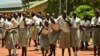 FILE - In this photo taken July 30, 2017, girls take a break at the Loreto Secondary School, the region's only all-girls boarding school where staff require each girl's guardian to sign a form promising not to remove the child from school until graduation, in the town of Rumbek, South Sudan.