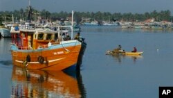  Lankan fishermen stand on a fishing vessel as it leaves a fishery harbor in Negombo, Negombo, outskirts of Colombo, Sri Lanka, Wednesday, Oct.15, 2014. In its fight against illegal fishing activities worldwide, the European Commissioner for Maritime Affairs and Fisheries, Maria Damanaki, on Tuesday announced a ban of imports of fisheries products from Sri Lanka to tackle the commercial benefits stemming from illegal fishing.(AP Photo/Eranga Jayawardena)