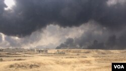 Most of the homes in this area remain empty as Iraqi and Peshmerga forces recapture villages. Many homes and businesses are in rubble, bombed by coalition airstrikes against IS, in Qayyarah, Iraq, Oct. 24, 2016. (H. Murdock/VOA)