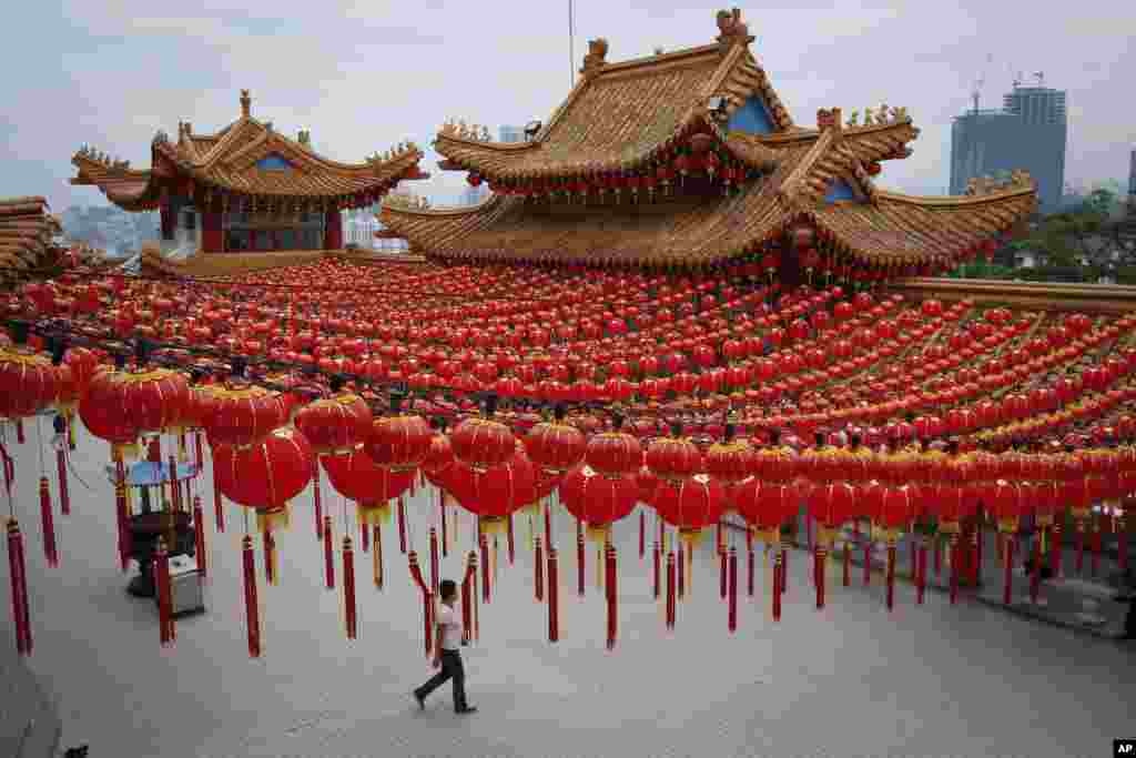 Ethnic Chinese pay a visit to a temple, decorated with Chinese traditional lanterns in preparation of the upcoming Chinese New Year, in Kuala Lumpur, Malaysia.