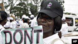 A lady carries placard at St. Leo Catholic church in Lagos, 09 Sept. 2010