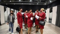 Flight attendants wait in the line to get a coronavirus disease (COVID-19) vaccine at the Belexpo vaccination centre, as Serbia started to immunize business people across the region, in Belgrade, Serbia, March 27, 2021. REUTERS/Zorana Jevtic