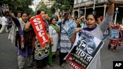 FILE - Activists of Socialist Unity Center of India-Marxist (SUCI-M) protest a recent case of child trafficking in West Bengal state in Kolkata, India, Nov. 29, 2016. Officials busted a child trafficking racket and rescued more than 20 children, according to news reports.