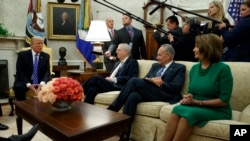 President Donald Trump speaks to, from left, Senate Majority Leader Mitch McConnell, R-Ky., Senate Minority Leader Chuck Schumer, D-N.Y., and House Minority Leader Nancy Pelosi, D-Calif., during a meeting with Congressional leaders in the Oval Office of the White House, Sept. 6, 2017, in Washington. 