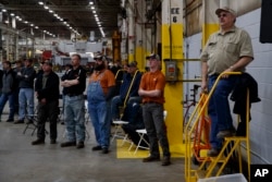 Workers listen as President Donald Trump delivers remarks at the Lima Army Tank Plant, March 20, 2019, in Lima, Ohio.