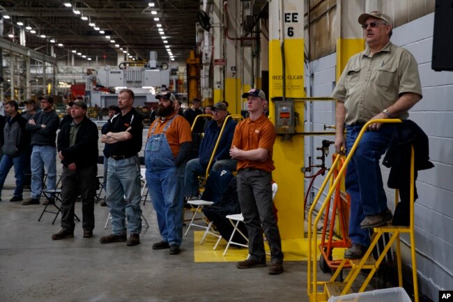 Workers listen as President Donald Trump delivers remarks at the Lima Army Tank Plant, March 20, 2019, in Lima, Ohio.