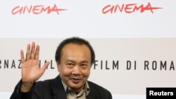Cambodian director Rithy Panh waves as he poses during a photo call, Oct. 24, 2008 (File)
