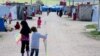 Children of foreign fighters play in the al-Roj camp in Syria, March 1, 2019. (H. Murdock/VOA)