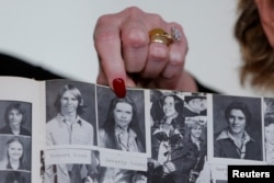 FILE - Accuser Beverly Young Nelson points to a photograph of herself in her high school yearbook after making a statement claiming that Alabama senate candidate Roy Moore sexually harassed her when she was 16, in New York, Nov. 13, 2017.