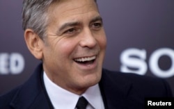 Cast member George Clooney arrives for the premiere of his movie "The Monuments Men" in New York, Feb. 4, 2014.
