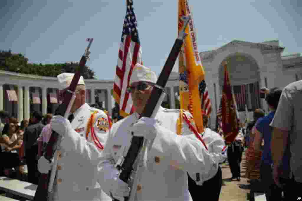 Honor Guard members depart after President Barack Obama speaks at the Memorial Day Observance at the Memorial Amphitheater at Arlington National Cemetery, Monday, May 28, 2012. (AP Photo/Charles Dharapak)