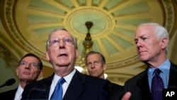 FILE - Senate Republican Majority Leader Mitch McConnell (2-L) speaks to reporters on Capitol Hill in Washington, May 10, 2016. Pressed by journalists Tuesday, McConnell said that he “wouldn’t be commenting” on the party’s presumptive presidential nominee this week.