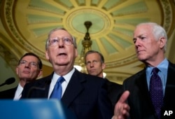 FILE - Senate Majority Leader Mitch McConnell of Ky., with, from left, Sens. John Barrasso, R-Wy., John Thune, R-S.D., and Senate Majority Whip John Cornyn, R-Texas, speaks to reporters on Capitol Hill in Washington, May 10, 2016.