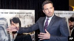 Director and actor Ben Affleck plays around while posing for photographers at the premiere of his film Argo in Washington, Wednesday, Oct. 10, 2012. 