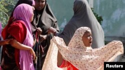 A Somali girl cries at the scene where her mother died as a result of a blast while sweeping a section of Taleh street in Mogadishu, August 3, 2014. 