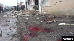 A view shows blood and bread on the ground after what activists said were missiles fired by a Syrian Air Force fighter jet from forces loyal to Syria's President Bashar al-Assad hit a bakery in Halfaya, near Hama December 23, 2012.