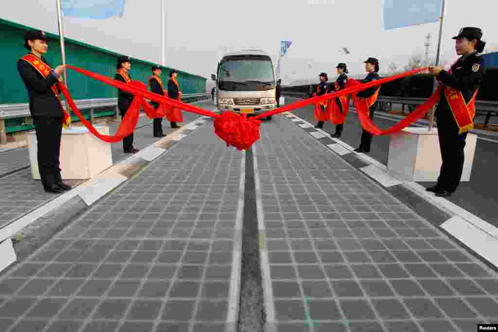 A vehicle is seen on a solar panel expressway during its opening in Jinan, Shandong province, China.