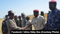 FILE - Chadian President Idriss Deby, 2nd on left, in hat, greets army officers at a military base in N'Djamena, Oct. 17, 2018.