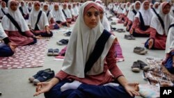 Indian Muslim students practice yoga at a school ahead of first International Yoga Day in Ahmadabad, India, Wednesday, June 17, 2015. 