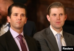 U.S. President Donald Trump's sons Donald Trump Jr. (L) and Eric Trump sit in the audience waiting to watch their father announce his nominee for the empty associate justice seat at the U.S. Supreme Court.