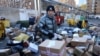 Delivery workers sort parcels at a makeshift logistics station near the Central Business District during Singles’ Day shopping festival in Beijing, China November 11, 2021.