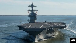 FILE - The USS Gerald R. Ford embarks on the first of its sea trials to test various state-of-the-art systems on its own power for the first time, from Newport News, Virginia, in an undated photo provided by the U.S. Navy.