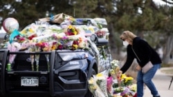 Karla Bielanski places flowers on the car of Officer Eric Talley, who was killed yesterday during a mass shooting in King Soopers grocery store, at Boulder Police Department, in Boulder, Colorado, U.S., March 23, 2021.