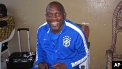 FILE - Liberian soccer star George Weah smiles inside a room in Monrovia, Liberia, Aug. 10, 2014. 