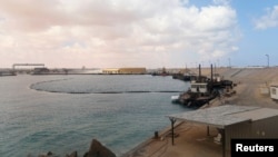 FILE - A view of part of the Es Sider oil export terminal in Ras Lanuf, west of Benghazi, March 11, 2014.