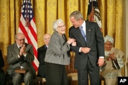 FILE - "To Kill a Mockingbird" author Harper Lee received the Presidential Medal of Freedom from President George W. Bush in 2007.