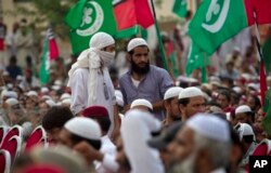 FILE - Supporters of banned sectarian group Sipah-e-Sahaba listen to their leaders at a gathering in Islamabad, Pakistan, Oct. 4, 2013.