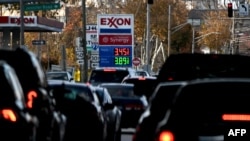 The price of gas is seen as traffic moves through Annapolis, MD, on November 23, 2021. - With inflation surging ahead of the Thanksgiving holiday, US President Joe Biden has drawn on the seldom-used Strategic Petroleum Reserve to combat rising oil prices 