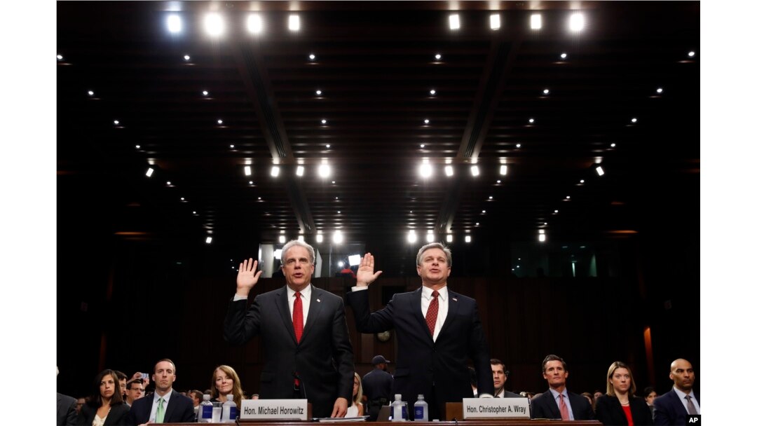 Department of Justice Inspector General Michael Horowitz, left, and FBI Director Christopher Wray are sworn in during a hearing of the Senate Judiciary Committee to examine Horowitz's report of the FBI's Clinton email probe, on Capitol Hill, June 18, 2018.