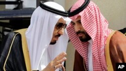 FILE - In this May 14, 2012 file photo, then Crown Prince Salman bin Abdul-Aziz Al Saud, left, speaks with his son Prince Mohammed as they wait for Gulf Arab leaders ahead of the opening of Gulf Cooperation Council, also known as GCC summit, in Riyadh, Sa