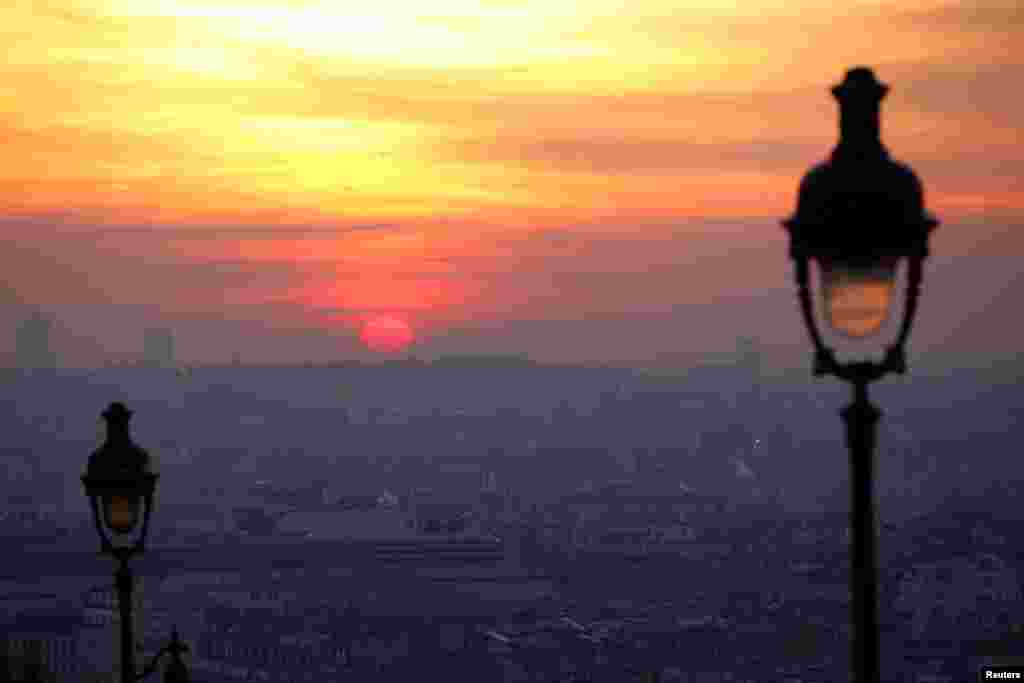 The sun rises as small-particle haze hangs above the skyline in Paris, France, as the City of Light experienced the worst air pollution in a decade.