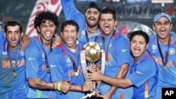 India's players hold the winning trophy as they celebrate their victory over Sri Lanka at ICC Cricket World Cup final match in Mumbai, April 2, 2011.