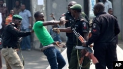 Nigerian police surround a protester during a Lagos demonstration against ending a fuel subsidy. (Reuters)