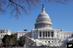 FILE - Work continues on the stand for the inauguration of President-elect Donald Trump on the west front of the Capitol in Washington, D.C., Dec. 28, 2016.