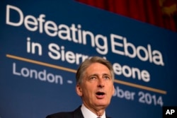 British Foreign Secretary Philip Hammond speaks as he holds a press conference with British International Development Secretary Justine Greening at an Ebola conference at Lancaster House in London, Oct. 2, 2014.