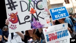 FILE - Demonstrators make their way around downtown July 25, 2016, in Philadelphia, during the first day of the Democratic National Convention after some of the 19,000 emails, presumably stolen from the DNC by hackers, were posted to the website WikiLeaks.